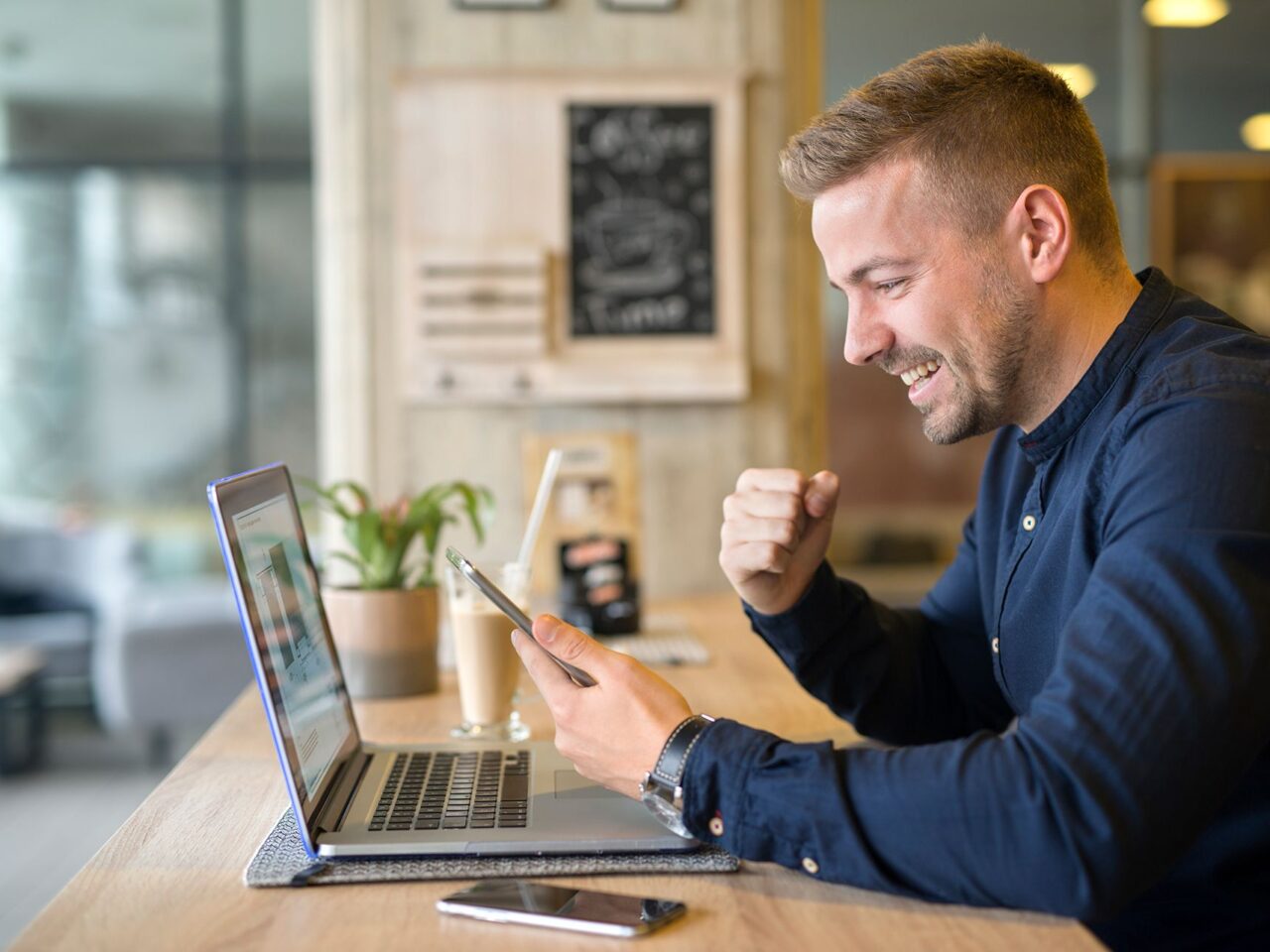 happy-freelancer-with-tablet-laptop-computer-coffee-shop